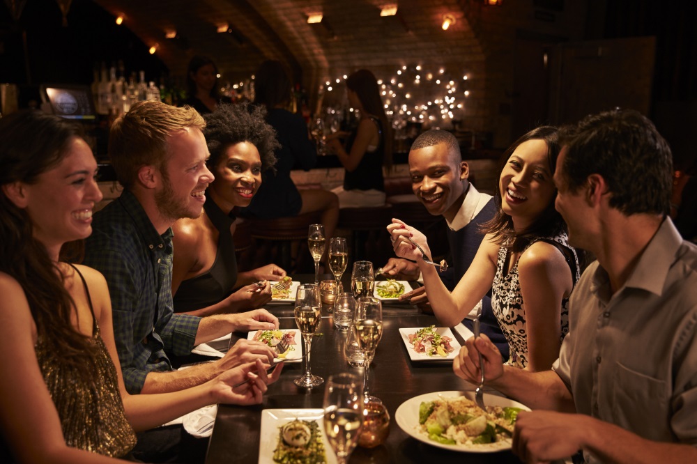 People sitting round table in restaurant